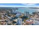 An aerial view of a coastal city featuring high-rise buildings, lush greenery, and stunning ocean views at 300 S Pineapple Ave # 802, Sarasota, FL 34236