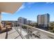 Spacious balcony with comfortable seating, glass railings, and panoramic city and water views at 300 S Pineapple Ave # 802, Sarasota, FL 34236