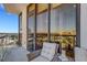 Relaxing balcony with wicker furniture, city views, and floor to ceiling windows at 300 S Pineapple Ave # 802, Sarasota, FL 34236