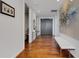 Bright hallway featuring wood floors and a modern design with a white bench and interesting artwork at 300 S Pineapple Ave # 802, Sarasota, FL 34236