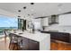 Modern kitchen with a center island and stainless steel appliances, a dining area, and an expansive view at 300 S Pineapple Ave # 802, Sarasota, FL 34236