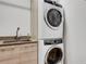 Efficient laundry room featuring a stacked washer and dryer and sink at 300 S Pineapple Ave # 802, Sarasota, FL 34236