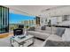 Bright living room with a modern kitchen, couch, and a balcony offering beautiful city views at 300 S Pineapple Ave # 802, Sarasota, FL 34236