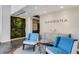 Modern lobby featuring blue chairs, decorative vases, and natural green wall accents at 300 S Pineapple Ave # 802, Sarasota, FL 34236