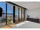 This modern bedroom features expansive windows with an attached balcony and city views at 300 S Pineapple Ave # 802, Sarasota, FL 34236