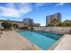 Community pool surrounded by tile patio, landscaping, and nearby high-rise buildings at 300 S Pineapple Ave # 802, Sarasota, FL 34236