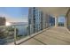 Expansive balcony with glass railings and stunning views of the water and city skyline at 301 Quay Commons # 1411, Sarasota, FL 34236