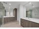 Spacious bathroom featuring dual vanities, large mirrors, and a glass enclosed shower at 301 Quay Commons # 1411, Sarasota, FL 34236