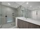 Modern bathroom featuring glass enclosed shower, vanity, and large mirror at 301 Quay Commons # 1411, Sarasota, FL 34236