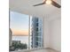 Modern bedroom with floor-to-ceiling glass window, allowing the breathtaking water view to come inside at 301 Quay Commons # 1411, Sarasota, FL 34236