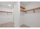 Walk-in closet with custom shelving and ample storage space at 301 Quay Commons # 1411, Sarasota, FL 34236