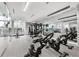 Well-equipped gym with stationary bikes, weights, and mirrors for a complete workout experience at 301 Quay Commons # 1411, Sarasota, FL 34236