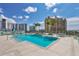 Rooftop pool and spa area surrounded by lounge chairs with beautiful city views at 301 Quay Commons # 1411, Sarasota, FL 34236