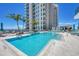 Resort-style pool surrounded by lounge chairs, umbrellas, and lush landscaping at 301 Quay Commons # 1411, Sarasota, FL 34236