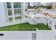 This rooftop terrace features a pool, sun loungers, turf, and a barbeque for the ultimate outdoor living experience at 301 Quay Commons # 1411, Sarasota, FL 34236