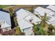 Aerial view of a house with white rooftop, green lawn and landscaped yard at 308 Bermuda Ct # 13, Venice, FL 34293