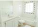 Bright bathroom with a tub and shower combination, tile floors, and decorative tiled window at 308 Bermuda Ct # 13, Venice, FL 34293