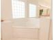 Elegant bathroom with tub and a glass block window at 308 Bermuda Ct # 13, Venice, FL 34293