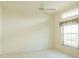 Bright bedroom features a ceiling fan and sunny window with custom valance at 308 Bermuda Ct # 13, Venice, FL 34293