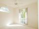 Bright bedroom with lots of natural light from the large window and vaulted ceiling with fan at 308 Bermuda Ct # 13, Venice, FL 34293