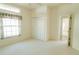 Bedroom features a large window, plush carpet and closet for ample storage at 308 Bermuda Ct # 13, Venice, FL 34293