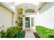 Charming front entrance with a walkway framed by lush plants, leading to a bright and welcoming doorway at 308 Bermuda Ct # 13, Venice, FL 34293