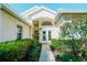 Inviting front entrance with lush landscaping, showcasing the home's curb appeal and welcoming ambiance with decorative plants at 308 Bermuda Ct # 13, Venice, FL 34293