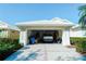 Spacious two-car garage with an open door, showcasing ample storage and parking space for a Gathering's vehicles at 308 Bermuda Ct # 13, Venice, FL 34293