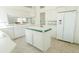 Well-lit kitchen with white cabinetry, an island, and a view into adjacent spaces at 308 Bermuda Ct # 13, Venice, FL 34293