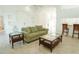 Well-lit living room featuring neutral tones, tile flooring, and a seamless flow into other living spaces at 308 Bermuda Ct # 13, Venice, FL 34293