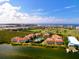 Aerial view of waterfront community with pool and golf course at 360 Gulf Of Mexico Dr # 332, Longboat Key, FL 34228