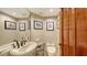 Small half bathroom with a toilet and sink at 360 Gulf Of Mexico Dr # 332, Longboat Key, FL 34228