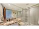 Bathroom with granite vanity, large mirror, and a walk-in shower at 360 Gulf Of Mexico Dr # 332, Longboat Key, FL 34228