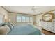 Bright bedroom with a comfortable bed, dresser, and window shutters at 360 Gulf Of Mexico Dr # 332, Longboat Key, FL 34228