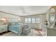 Main bedroom with large windows, hardwood floors, and dresser at 360 Gulf Of Mexico Dr # 332, Longboat Key, FL 34228