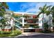 Three-story building with balconies and lush landscaping at 360 Gulf Of Mexico Dr # 332, Longboat Key, FL 34228