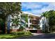 Three-story building with balconies and lush landscaping at 360 Gulf Of Mexico Dr # 332, Longboat Key, FL 34228