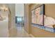 Hallway with artwork and view into living area at 360 Gulf Of Mexico Dr # 332, Longboat Key, FL 34228