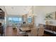 Bright living room with water views, fireplace, and hardwood floors at 360 Gulf Of Mexico Dr # 332, Longboat Key, FL 34228