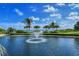 Relaxing pond with a fountain and palm trees at 360 Gulf Of Mexico Dr # 332, Longboat Key, FL 34228