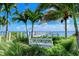 Peaceful waterfront view with a white bench at 360 Gulf Of Mexico Dr # 332, Longboat Key, FL 34228