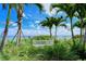 Serene waterfront view with a white bench at 360 Gulf Of Mexico Dr # 332, Longboat Key, FL 34228