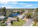 Aerial view of waterfront home with lush greenery, showcasing its location near a beautiful lake and cozy neighborhood at 3718 61St St, Bradenton, FL 34209