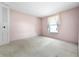 This bedroom has carpet and a louvered closet door at 3718 61St St, Bradenton, FL 34209