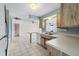 Kitchen featuring light blue accents, a breakfast bar, and tile floors at 3718 61St St, Bradenton, FL 34209