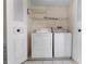 Cozy laundry room with side by side washer and dryer units and shelving at 3718 61St St, Bradenton, FL 34209