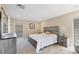 Main bedroom with a gray wood bed frame and carpeted floors at 3749 Amesbury Ln # 5608, Sarasota, FL 34232