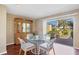 Bright dining area with glass table and chairs, and sliding door to patio at 3749 Amesbury Ln # 5608, Sarasota, FL 34232