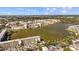 Expansive aerial shot showcases an apartment complex encircling a serene lake, highlighting its picturesque setting at 4126 Heron Way # B113, Bradenton, FL 34205