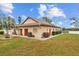 Community building featuring beautiful landscaping, red doors, and convenient access to the waterfront at 4126 Heron Way # B113, Bradenton, FL 34205